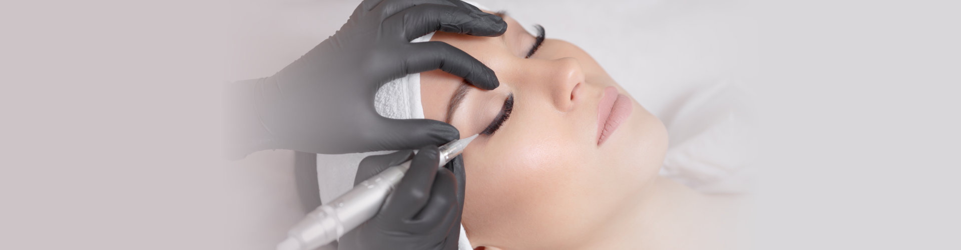 a woman having a permanent eyebrow tattoo